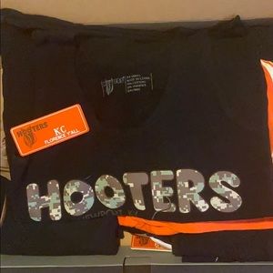 Box of used Hooters uniforms